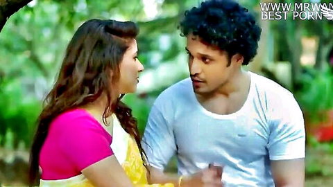 Indian wife in pink blouse and yellow saree with friend in outdoor intimate scene