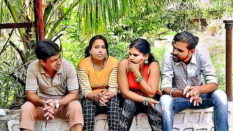Desi Indian group with two women in casual tops and men outdoors