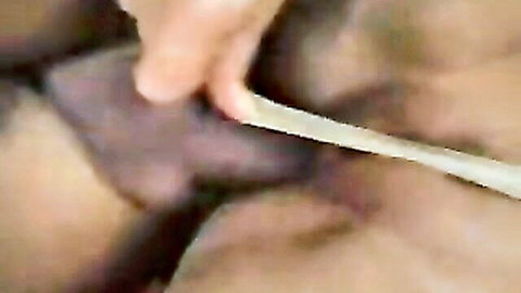 Close-up of hand inserting object in anal area with sexy legs visible
