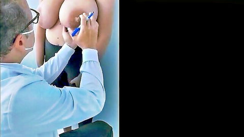 Doctor marking huge bare tits with blue pen during medical breast exam