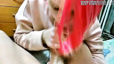 Pink-haired e-girl fingers her wet pussy while spreading legs on bed