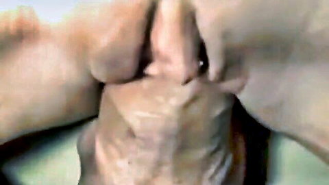 Closeup of woman's fingers spreading shaved pink pussy lips exposing wet inner labia and clit