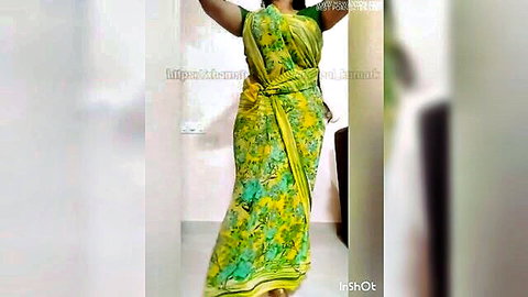 Sexy Indian woman in yellow-green saree lifting arms seductively posing for voyeur cam