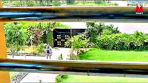 Amateur couple walking in lush garden, outdoor setup for Kamagni part 1
