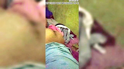 Blurry closeup of Asian woman's big ass in pink panties on green bed
