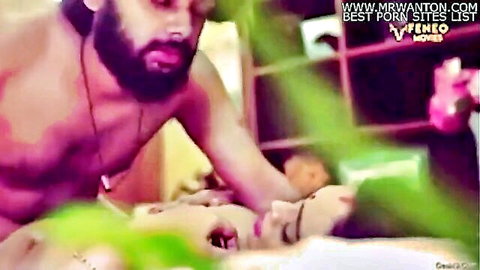Bearded Indian man intimately embracing curvaceous woman in passionate scene