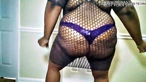 Curvy ebony woman teasing dance in fishnet lingerie and purple thong