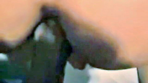 Close-up of woman's dark-skinned ass with dildo anal insertion