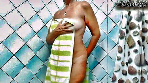 Lukerya in shower wrapped in towel, teasing side profile nude reveal