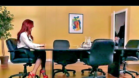 Sexy redhead businesswoman in white blouse and skirt at office table