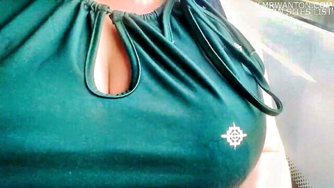 Curvy brunette in revealing green keyhole dress showing deep cleavage on vacation drive
