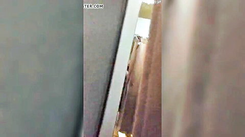 Blurry naked woman bends over exposing bare ass in public laundromat store