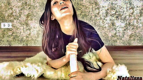Petite long-haired teen moans ecstatically gripping white dildo between spread legs on fluffy rug