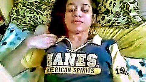 Sexy Malaysian babe lying on bed in open Hanes American Spirits jacket teasing cleavage and tits