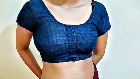 Busty Indian desi woman in tight black blouse and red skirt, exposed midriff
