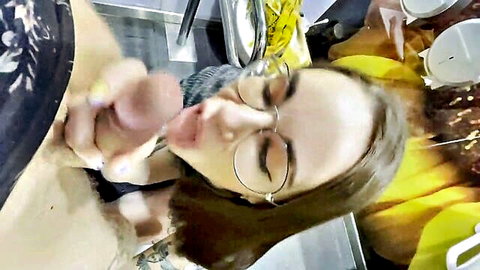 Nerdy brunette in glasses slurps thick cock in public restroom blowjob
