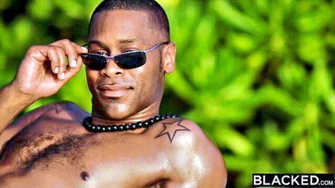 Muscular black stud with sunglasses, star tattoo and necklace poses outdoors on Blacked.com