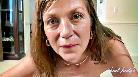 Mature brunette MILF Aunt Judy stares seductively at POV camera with pouty lips
