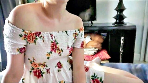 Dakota Burns in white floral off-shoulder dress, teasing seated pose