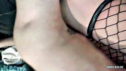 Swinger wife in fishnet lingerie showing thigh tattoo in orgy tease
