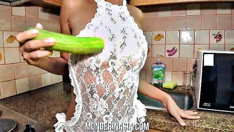 Sexy Thai woman in white lace lingerie teasing with cucumber