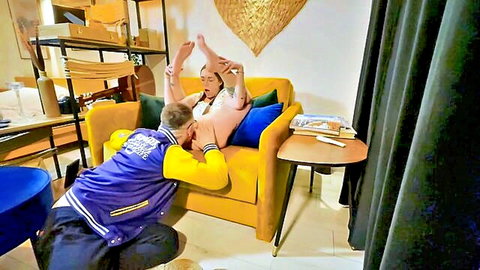 Slim girl legs up on couch getting oral from guy in varsity jacket