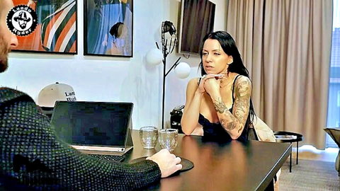 Tattooed brunette in low-cut top during casting interview