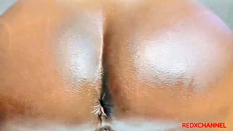 Close-up of oiled Jamaican ebony big ass with visible anus