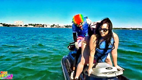 Virgo Peridot with Gibby the Clown on jet ski in ocean, curvy ebony babe in life vest