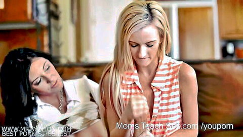 Blonde and brunette women in revealing tops, intimate on couch