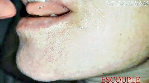 Woman with tongue piercing sticks out tongue covered in thick cum after blowjob