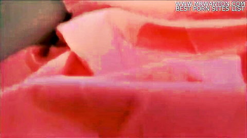 Blurry pink fabric closeup with heavy porn site watermarks overlay