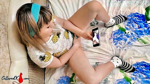 Cute Asian girl in pineapple onesie sucks lollipop and fingers wet pussy closeup