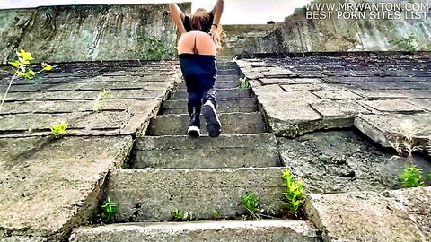 Blonde woman exposing big ass climbing outdoor concrete stairs in dangerous public tease