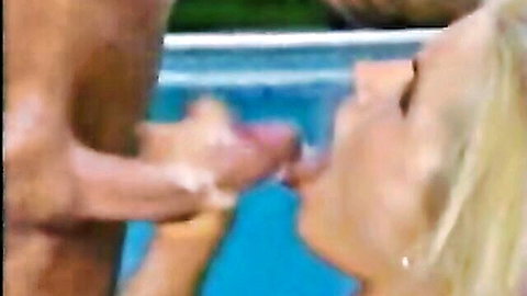 Blonde mature woman with big tits lips on throbbing cock by pool