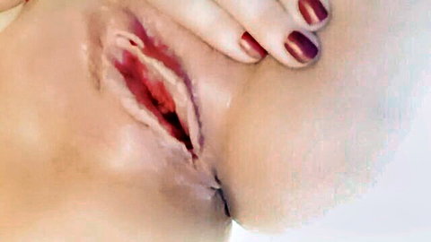 Close-up of woman's aroused pussy during intense orgasm with hand touch