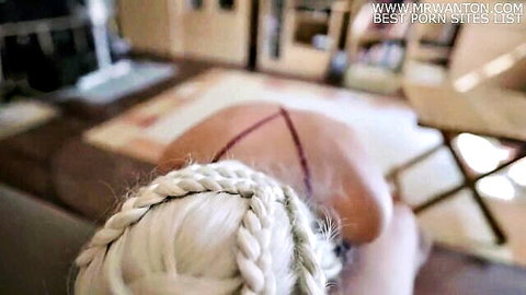 Blonde Daenerys cosplay woman kneeling in red straps, back view