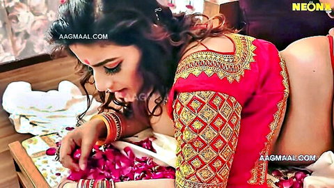 Indian woman in red saree blouse picking rose petals, teasing cleavage in Misti Bala short film