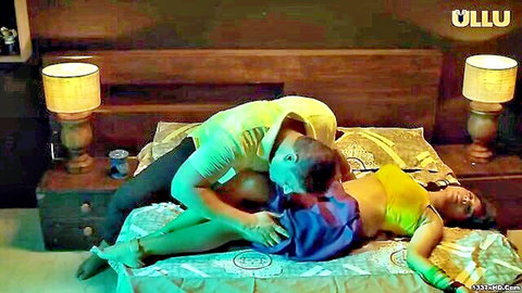 Busty Indian woman in yellow saree gets kissed and groped by man during foreplay on bed