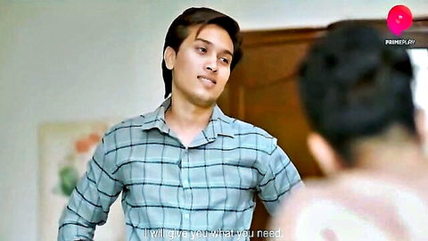 Handsome Indian man in checkered shirt smiles saying 'I will give you what you need'
