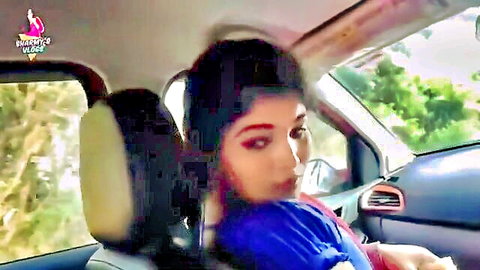 Seductive Indian cutie in blue top glancing back in car seat