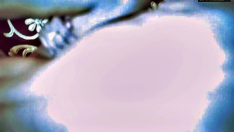 Blurry closeup of pink fleshy pussy lips with gold jewelry chains nearby
