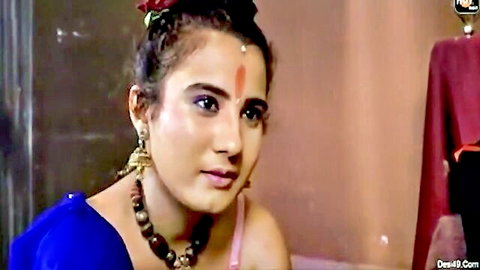 Sexy Indian brunette MILF in blue saree blouse with bindi and jewelry looking seductive