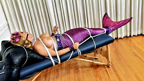 Carissa blonde mermaid bound in ropes, exposed tits BDSM pose