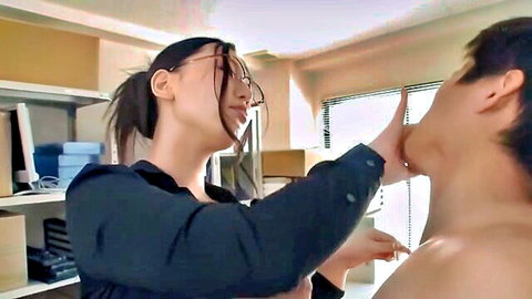 Japanese MILF with glasses grips young man's face in office seduction
