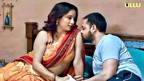Desi woman in orange saree kissed intimately by man in Ullu Hindi web series