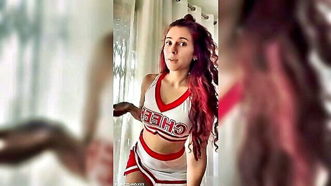 Redhead cheerleader teen in skimpy uniform teasing big tits and ass with surprised O-face