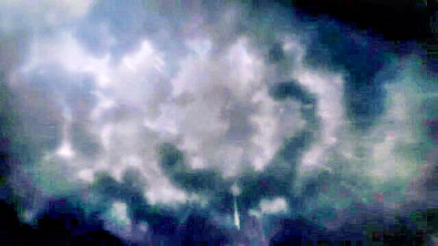 Swirling white clouds vortex in dark blue stormy sky.