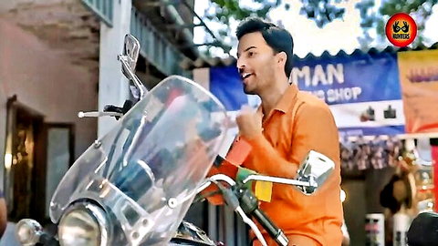 Smiling Indian man in orange shirt by motorcycle in Devika Hindi hot web series thumbnail