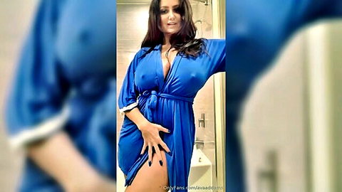 Ava Addams teasing in open blue robe, showing deep cleavage in bathroom